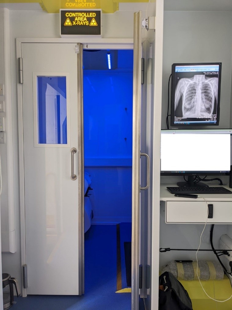 Double door into x-ray room of Find & Treat mobile health unit, x-ray image displays on right-hand side screen