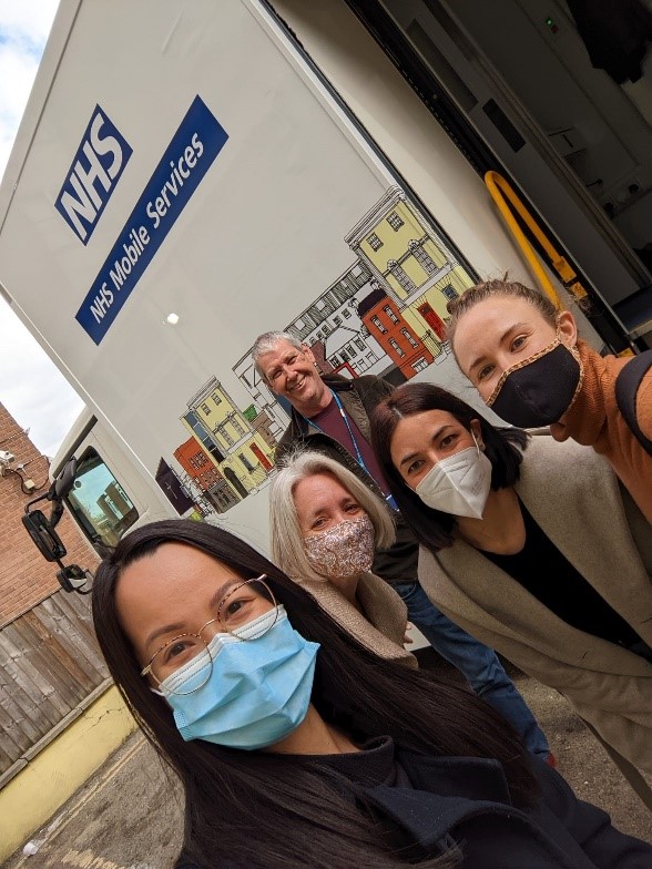 Homeless health team members with face masks outside the Find & Treat mobile health unit. 