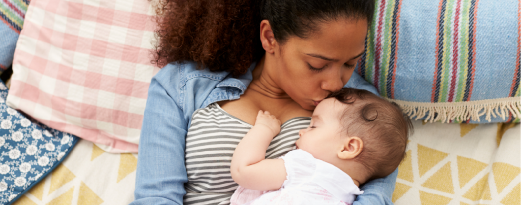 Mother kissing child