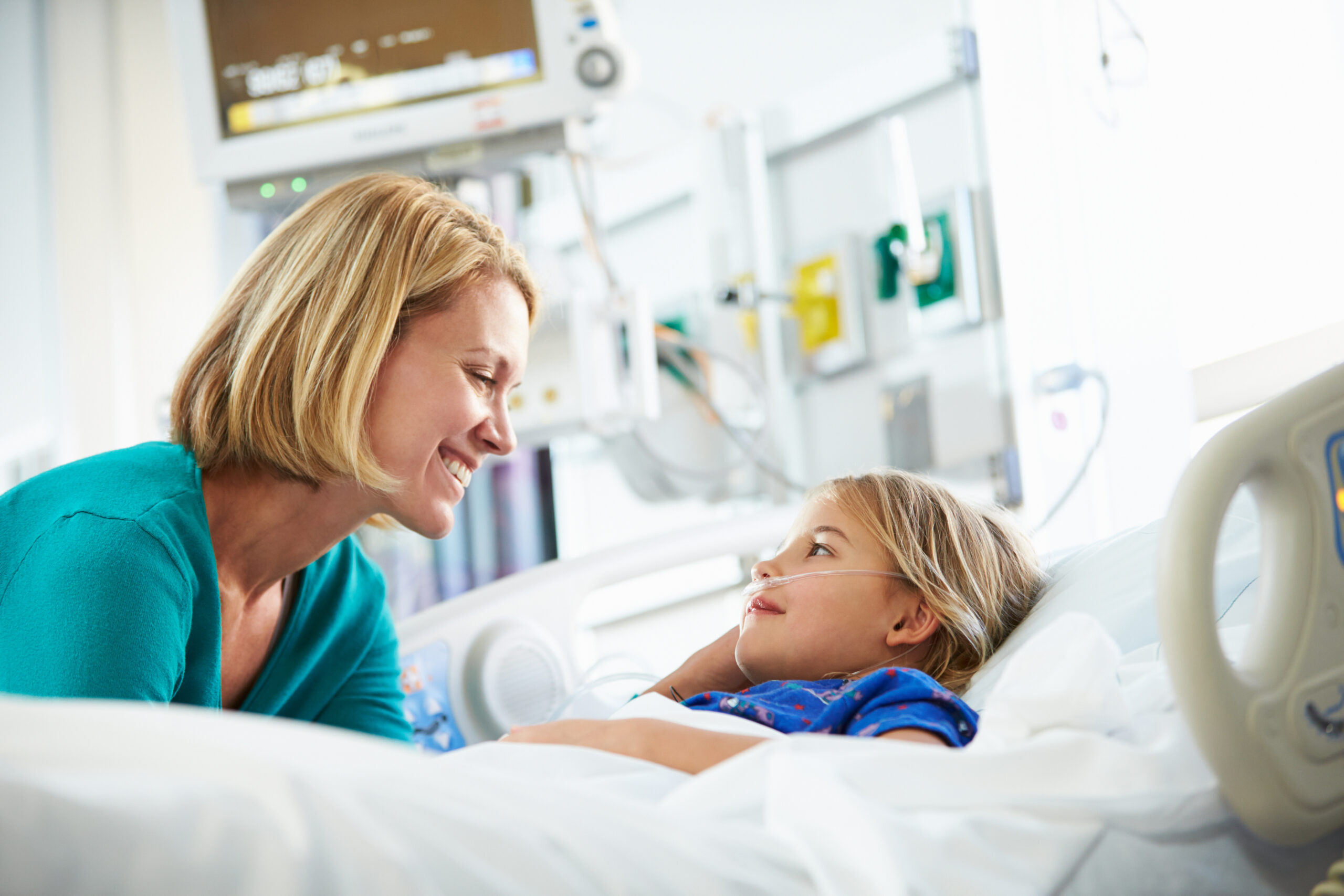Child in hospital bed with mother