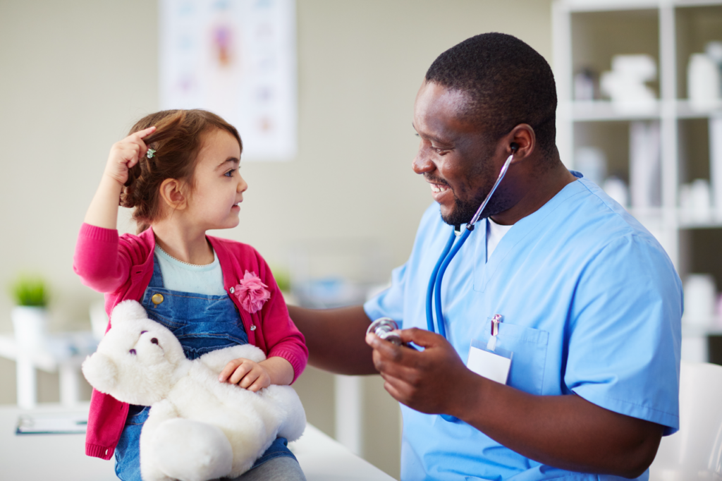 Young girl with a fluffy toy talking to a male doctor
