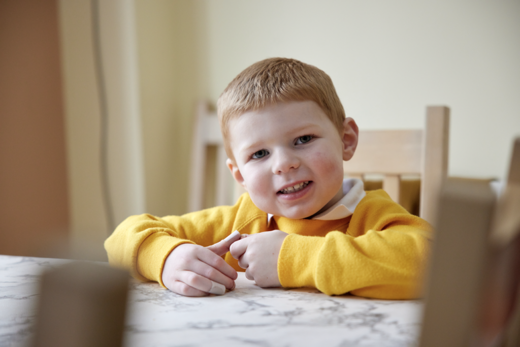 Boy with yellow jumper