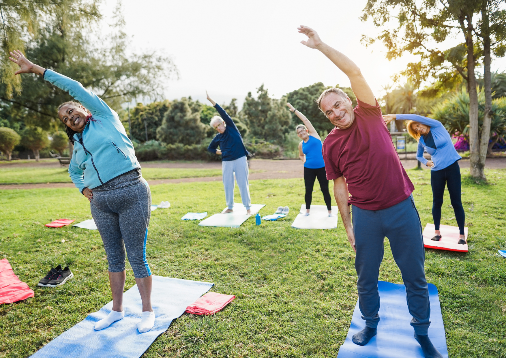 A group of people stretching in a park