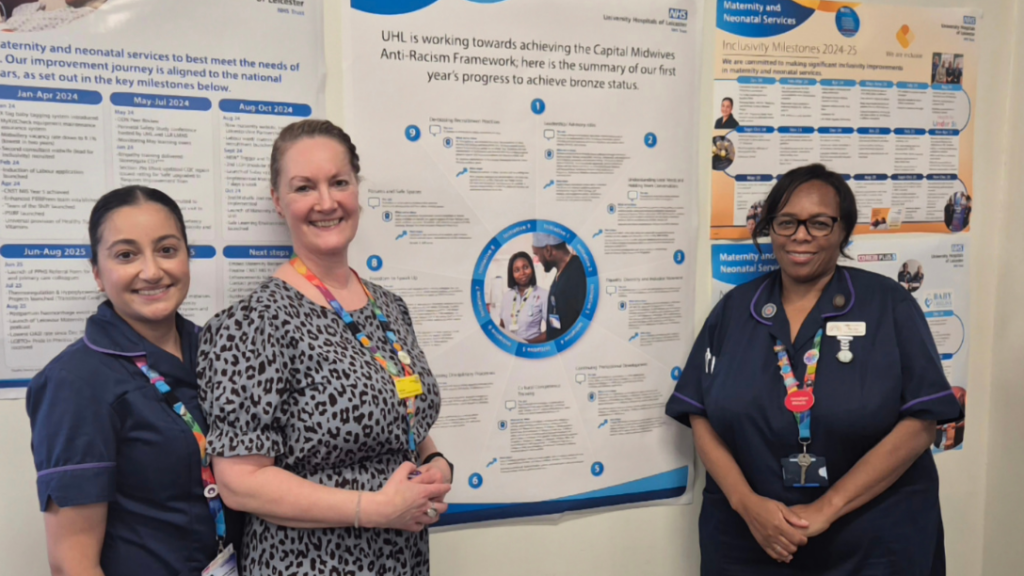 Three UHL colleagues standing next to a chart