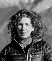 Emily Righini-Nisbet, Senior Consultant stood outside with a comfy jacket and scarf