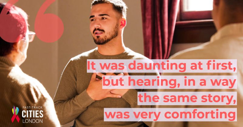 A young man speaks to two other people in a warmly lit room, holding a hand to his chest during what appears to be a group discussion or support session. Overlaid text reads: ‘It was daunting at first, but hearing, in a way, the same story, was very comforting’. The Fast-Track Cities London logo appears in the bottom left corner.
